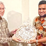 MIMRA Coastal Fisheries official Bryant Zebedy presents a Marshallese handicraft to Japan Ambassador Toshinori Shigeie, the president of the Association for Promotion of International Cooperation. APIC supports a range of leadership and study programs for Marshallese and citizens of Palau and the FSM. Photo: Giff Johnson.