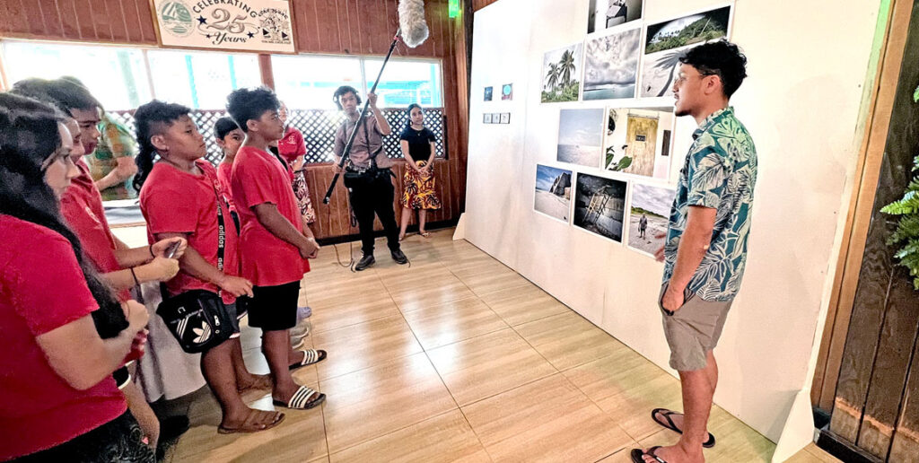 Jo-Jikum staff member Jobod Silk, right, explained exhibits at the Nuclear Art exhibition at the Marshall Islands Resort to visiting Coop students last Thursday. Photo: Giff Johnson.