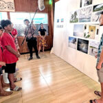 Jo-Jikum staff member Jobod Silk, right, explained exhibits at the Nuclear Art exhibition at the Marshall Islands Resort to visiting Coop students last Thursday. Photo: Giff Johnson.