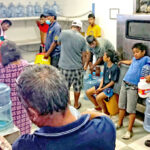 Majuro residents of all ages crowd into the Payless water filling facility to buy drinking water. As the El Niño-caused drought has intensified in Majuro, all of the water making businesses have seen long lines of people waiting to fill gallon containers. Photo: Wilmer Joel.