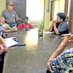 Taxi Drivers Association President Annej Ishiguro, standing, speaks to Deputy Attorney General Johnathan Kawakami, left, and EPPSO Director Fred deBrum, right, during a meeting concerning the recently raised taxi fares. Photo: Wilmer Joel.