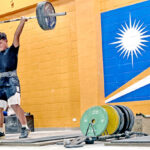 The Micro Games Weightlifting team works out nightly at the ECC gym. Here, weightlifter Massey Atantaake, works on his lifting techniques. Photo: Giff Johnson.