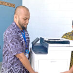 Auditor General’s Office Investigative Auditors Thompson Hanchor and Randall Mckay carry out equipment from CMI Tuesday. Photo: Hilary Hosia.