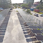 A drone photo offers a bird’s eye view of the solar panels installed at the Public School System parking lot. Photo: Green Energy Solutions.