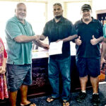 At the handover of the check on Monday morning, from left: Ministry of Natural Resources and Commerce Secretary Iva Reimers, Minister Tony Muller, RMI Love Animals Director Josh Lanki and Deputy Director Daniel Kramer.