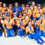 The RMI women’s fast pitch team, with Coach Helkena Annihilations center back in blue, shows off its gold medals Saturday following an undefeated Micro Games performance. Photo: Chewy Lin.