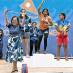 Marshall Islands President Hilda Heine was on hand for Mattie Sasser Miller’s three-gold weightlifting performance at the ICC Monday. The President is holding one of Mattie’s gold medals before putting it around her neck. Photo: Australian Embassy.
