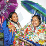 CMI Graduates Norlynn Lewis and Jasmiann Ebol were uniquely endowed by relatives and friends with gift umbrellas to go with their many leis. Photo: Wilmer Joel.