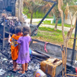 The house in Delap was a total loss after the Saturday fire. Children sift through the wreckage. Photo: Hilary Hosia.