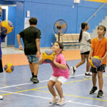 Coach and RMI national team player Melu Wase instructs younger players in shooting techniques during the Marshall Islands Basketball Federation-sponsored clinic at the ECC gym last weekend. Photo: Hilary Hosia.