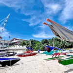 Outrigger canoes line the beach at Eneen Jabro Island in Kwajalein Atoll last weekend. Photo: Alson Kelen.
