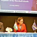 In Tokyo in the lead up to the PALM declaration, Ambassador of India to RMI Sibi George, left, and Marshall Islands Foreign Minister Kalani Kaneko, right, signed the new aid agreement as President Hilda Heine looks on.