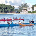 Paddling in Majuro lagoon. Pictured in the front canoe are, from left to right, Tatiana Shoniber, Lita Flood, Kaili Kramer, Angella Yen, Andrea Muller, and Chloe Abraham. In the back canoe are Malia Shoniber, Shamanda Hang, Alexy Joseph, Cukki Kabua, Alexandra Lutuni, and Isabel Kramer. Photo: Cary Evarts.