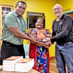 USP Campus Director Setoki Qalubau, left, and Librarian Lynn N. Miano received a donation of “News Zero: The New York Times and The Bomb” books from Giff Johnson, who delivered them on behalf of the author Beverly Ann Deepe Keever.