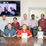 Health Minister Ota Kisino, seated center, and Health Secretary Francyne Wase-Jacklick hold up the two newly signed agreements with India-based company Aprameya Medical Ltd. representatives, who can be seen on the screen at back. The two agreements relate to resuming dialysis services after a nearly 40-year hiatus in this service in Majuro. Photo: Chewy Lin.