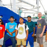 With the S/V Juren Ae in the back, pictured from left are the three new interns working on the vessel: Lina Harry, Tony7 Freddy and Kano Peralta. With them is Captain Teitera Turei, the Low Carbon Transport Project’s Technical Intern Michel Gruther, and Martime Training Center Director Edward Adiniwin.