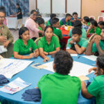 Life Skills Academy students discuss fisheries presentations during a breakout group along with cultural resource person Solynn Bajo. Photo: Chewy Lin.