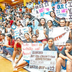 Enthusiastic fans show off their signage at the basketball championship games held at the ECC national gym last Friday in Majuro. Photo: Chewy Lin.
