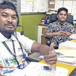 Imaikta Junior (left) and Dickson Lomae handle debit cards for Bank of Marshall Islands at its main branch in Uliga. Photo: Hilary Hosia.