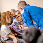 Kwajalein Commander Col. Drew Morgan, wearing his astronaut uniform, asks a student for feedback during the live interaction with NASA astronauts in the International Space Station. Photo: Sherman Hogue.