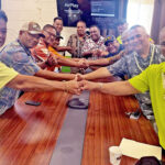At the handover ceremony for the “Kwajalein Boat” to be transferred from KALGov authority to the Lae Local Government, front: Public Works Minister and Lae Nitijela Member Thomas Heine shakes with Mayor Hirata Kabua. Behind them, Lae Mayor Telmong Kabua and Finance Minister David Paul shake as do other KALGov and Lae officials at the ceremony. Photo: Hilary Hosia.