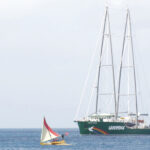 A Waan Aelon in Majel (Canoes of the Marshall Islands) outrigger welcomes the Rainbow Warrior to Majuro Tuesday this week. Photo: Gary Ehsram.
