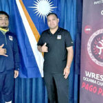 RMI gold medal winning wrestler JR Bremen Leban, left, with Coach and RMI Wrestling Federation head Waylon Muller at the Oceania Championships in American Samoa last week.