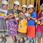 Hard hats are protecting these five young women who are part of WAM’s six-month life and vocational skills training and who are helping to build WAM’s new two-story building. From left: Melcy Minajet, Mina Jejom, Badilan Jibom, Daisy Menajet, and Atherria DeBrum. Not pictured is one additional female training participation, Karlinda Abta. Photo: Waan Aelon in Majel.