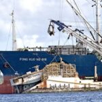 The Fong Kuo No. 818 tuna carrier vessel dwarfs the purse seiner next to it with the unique name: New Canoe. Photos: Karen Earnshaw.