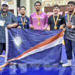 Marshall Islands Wrestling Federation representative Damien Jacklick, second from left, with RMI wrestlers at the Palau Mini-Games. The RMI wrestlers won half of RMI’s 12 medals at the Mini-Games.