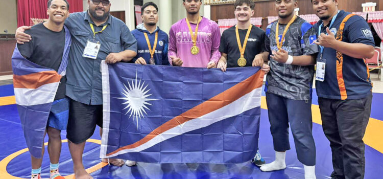 Marshall Islands Wrestling Federation representative Damien Jacklick, second from left, with RMI wrestlers at the Palau Mini-Games. The RMI wrestlers won half of RMI’s 12 medals at the Mini-Games. Wrestlers dominate RMI medals
