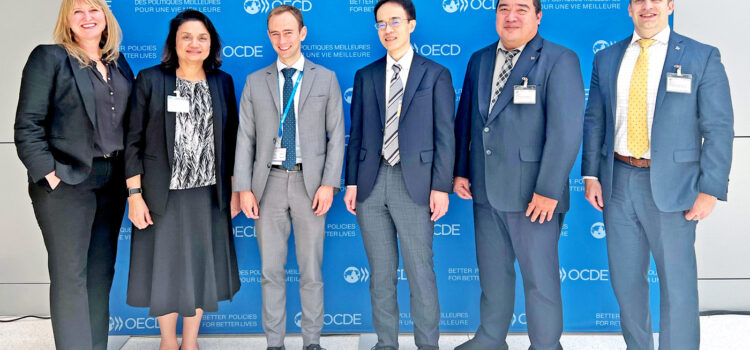 At the Paris OECD meetings, from left: Meredith Kirby, Ann Marie S. Muller, OECD Global Forum Secretariat’s Mark Scott, Hirotaka Katou, James Myazoe, and Ryan Gibson. Finance meets with OECD