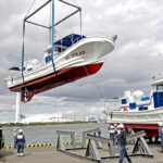 The MS Bikar is hoisted at the start of its trip from Japan to the Marshall Islands. The MS Bokak awaits its turn. Photo: Takuma Takyama.