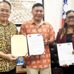 Taiwan Embassy Chargé Hank C.C. Liu hands a check for $7.8 million to Foreign Minister Kalani Kaneko and Acting Finance Secretary Sana Anien.