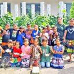 Wotje students with teachers and Wellness Center trainers with their garden at back.