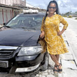Taxi driver Elizabeth Marques, one of the few women drivers in Majuro, poses next to her ride in Delap earlier this week. Photo: Karen Earnshaw.