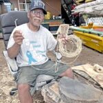 Master canoe builder and trainer Binton Daniel, in the Waan Aelon in Majel canoe workshop, shows off the “ekwal” (coconut fiber rope) that he was making when we stopped by the program. Photo: Giff Johnson.