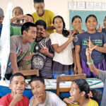 Seventh and eighth grade students at Wotje Elementary School with the Panda Express miniboat.