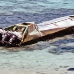 This drug-running speed boat washed into Arno Atoll earlier this month. Known by law enforcement as a “narco boat,” the vessel sports four big outboard engines for high speed transport of drugs in the submarine-like enclosed hull. RMI law enforcement authorities said they are looking into the matter. Photo: Arthmen Laukon.