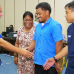 Minister Tony Muller, left, who doubles as the president of the National Olympic Committee, shakes hands with JR Bremen Leban and and Myron Langinlur at Nitijela Monday. Photo: Goodwind Silk.